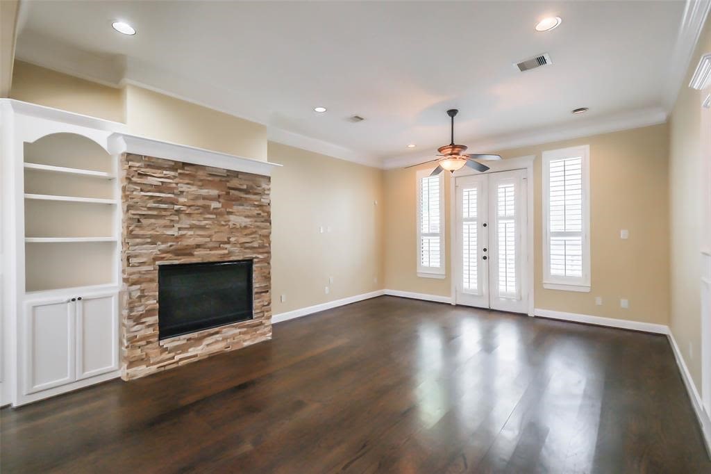 706 Allston Street, Unit B Houston, TX 77007 - Photo 6 of 33 an empty room with wooden floor fireplace and windows