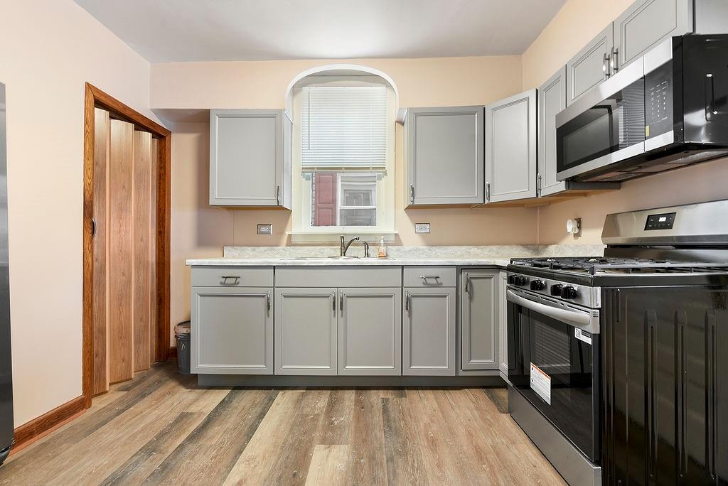 3518 7th Avenue Beaver Falls, PA 15010 - Photo 12 of 28 a kitchen with stainless steel appliances granite countertop a stove a sink and a microwave