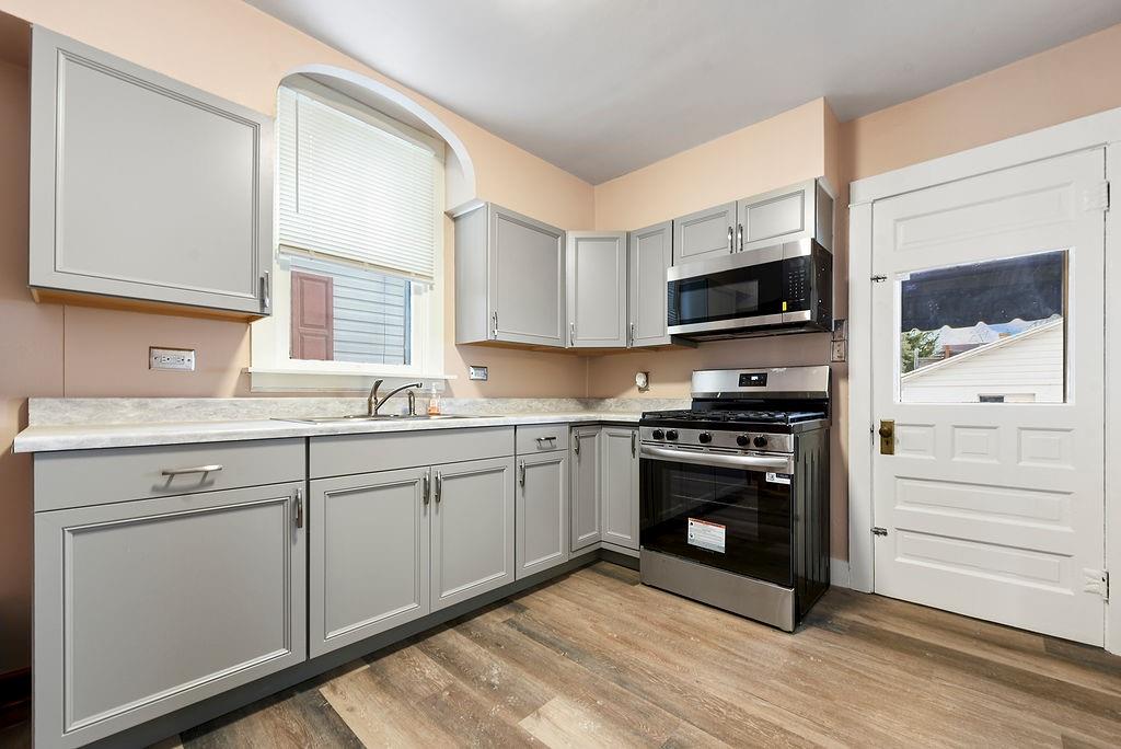 3518 7th Avenue Beaver Falls, PA 15010 - Photo 14 of 28 a kitchen with a sink stove and microwave