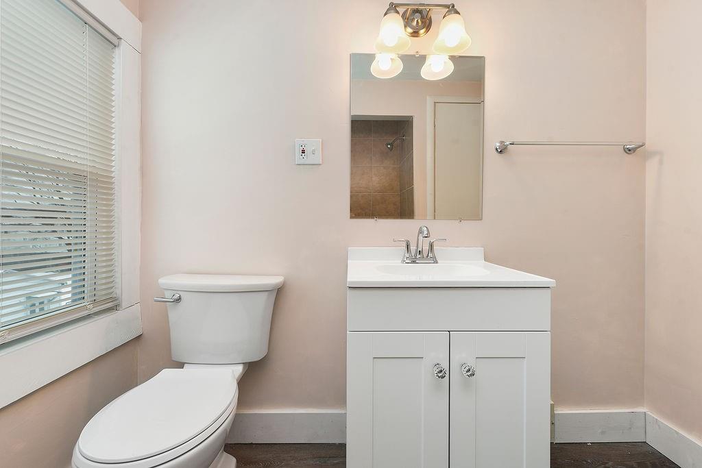 3518 7th Avenue Beaver Falls, PA 15010 - Photo 16 of 28 a bathroom with a toilet a sink and a mirror