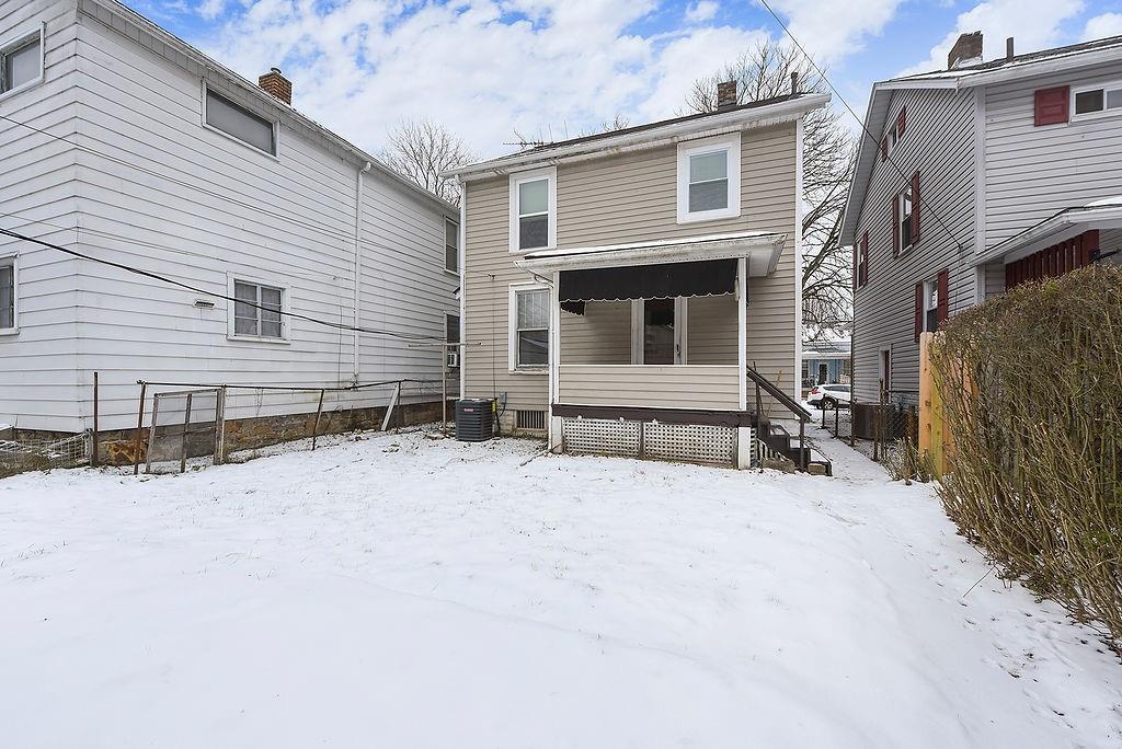 3518 7th Avenue Beaver Falls, PA 15010 - Photo 27 of 28 a front view of a house with a yard covered in snow