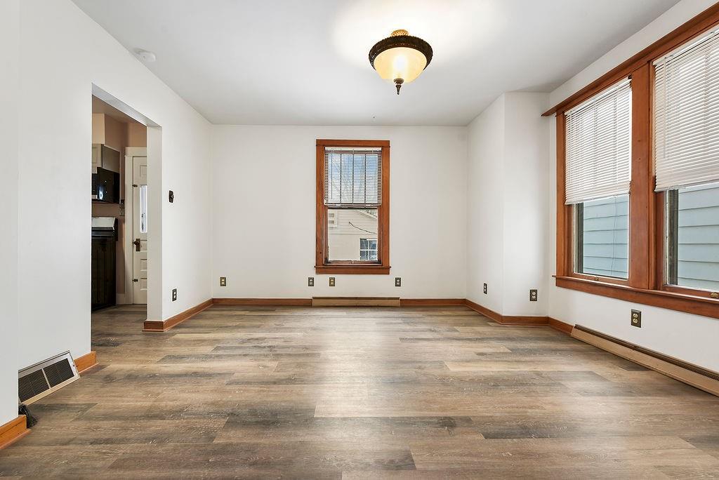 3518 7th Avenue Beaver Falls, PA 15010 - Photo 8 of 28 a view of an empty room with a window and wooden floor