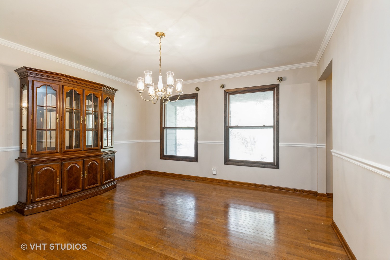 1335 Zange Drive Algonquin, IL 60102 - Photo 5 of 22 a view of an empty room with wooden floor and a window