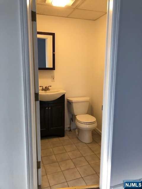 21 Columbus Street Bloomfield, NJ 07003 - Photo 8 of 20 a bathroom with a toilet sink and mirror