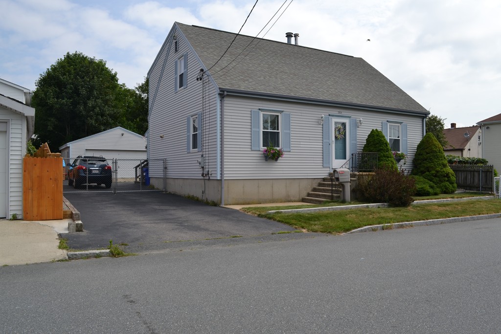 252 Pelham Street Fall River, MA 02721 - Photo 1 of 18 a front view of a house with a yard and garage