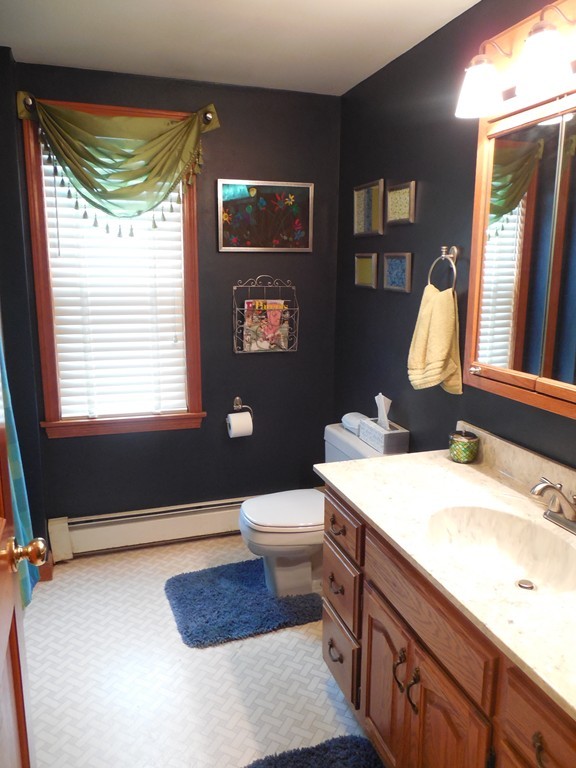 252 Pelham Street Fall River, MA 02721 - Photo 13 of 18 a bathroom with a double vanity sink toilet and a mirror