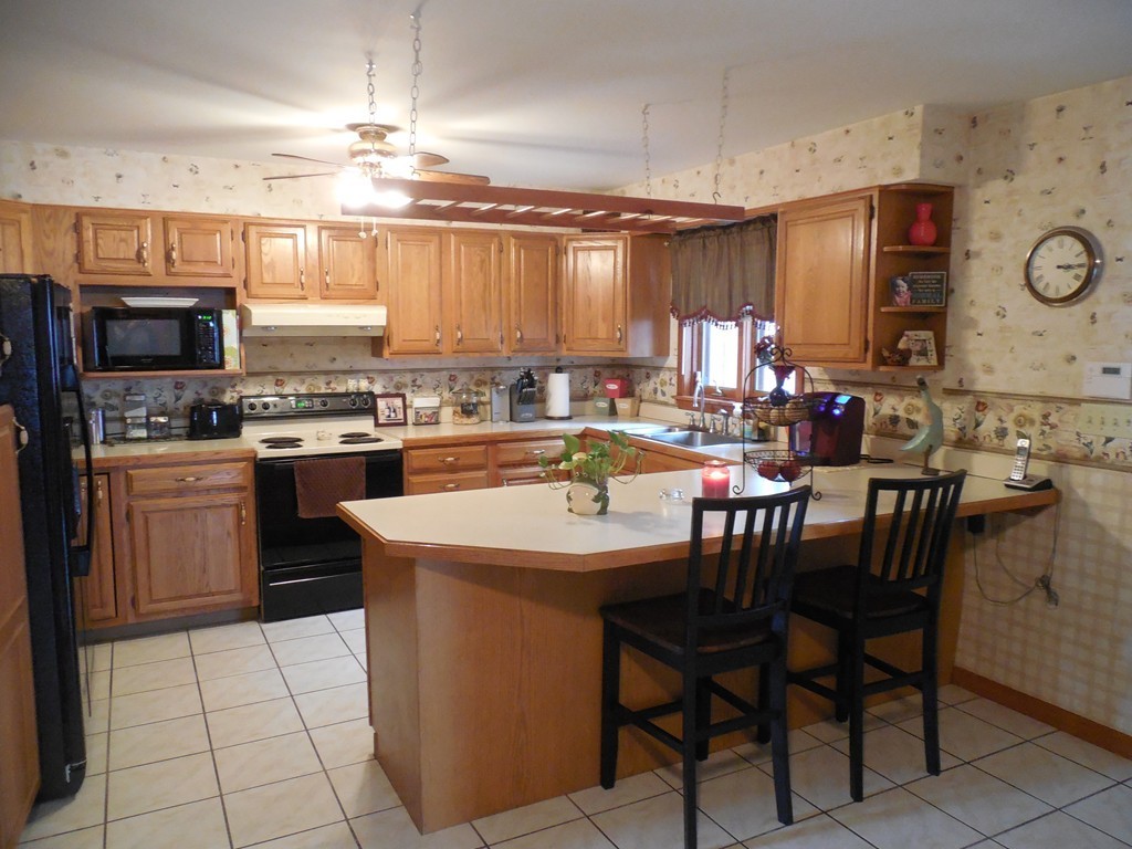 252 Pelham Street Fall River, MA 02721 - Photo 9 of 18 a kitchen with a sink a counter top space appliances and cabinets