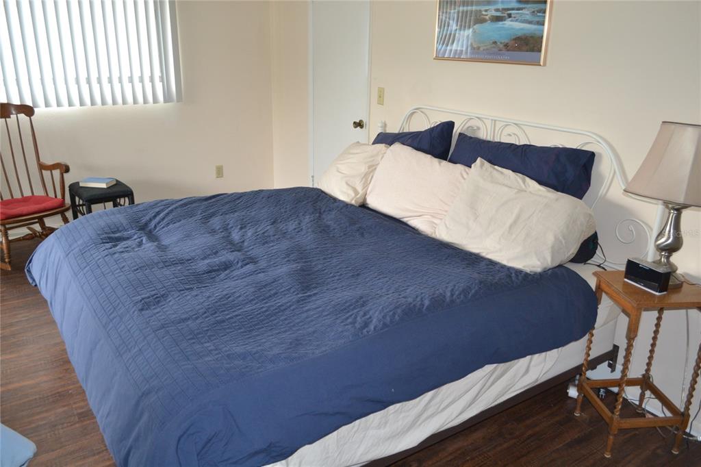 2375 Fox Chase Boulevard, Unit 260 Palm Harbor, FL 34683 - Photo 11 of 38 a bedroom with a bed and a chair