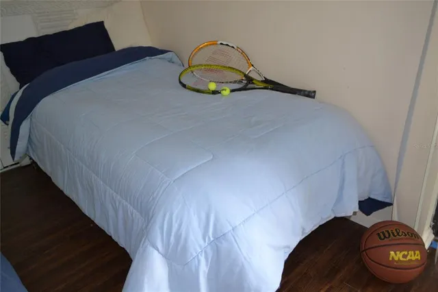 a bedroom with a bed and a lamp