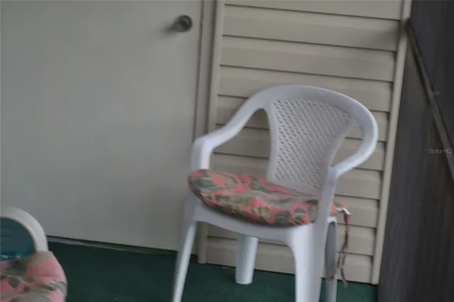 a living room with furniture and a chair