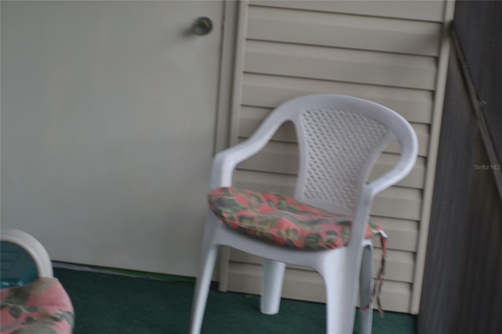 2375 Fox Chase Boulevard, Unit 260 Palm Harbor, FL 34683 - Photo 15 of 38 a living room with furniture and a chair