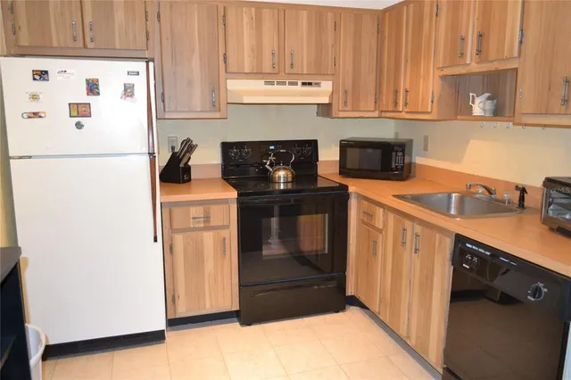 a kitchen with stainless steel appliances granite countertop a refrigerator and a stove