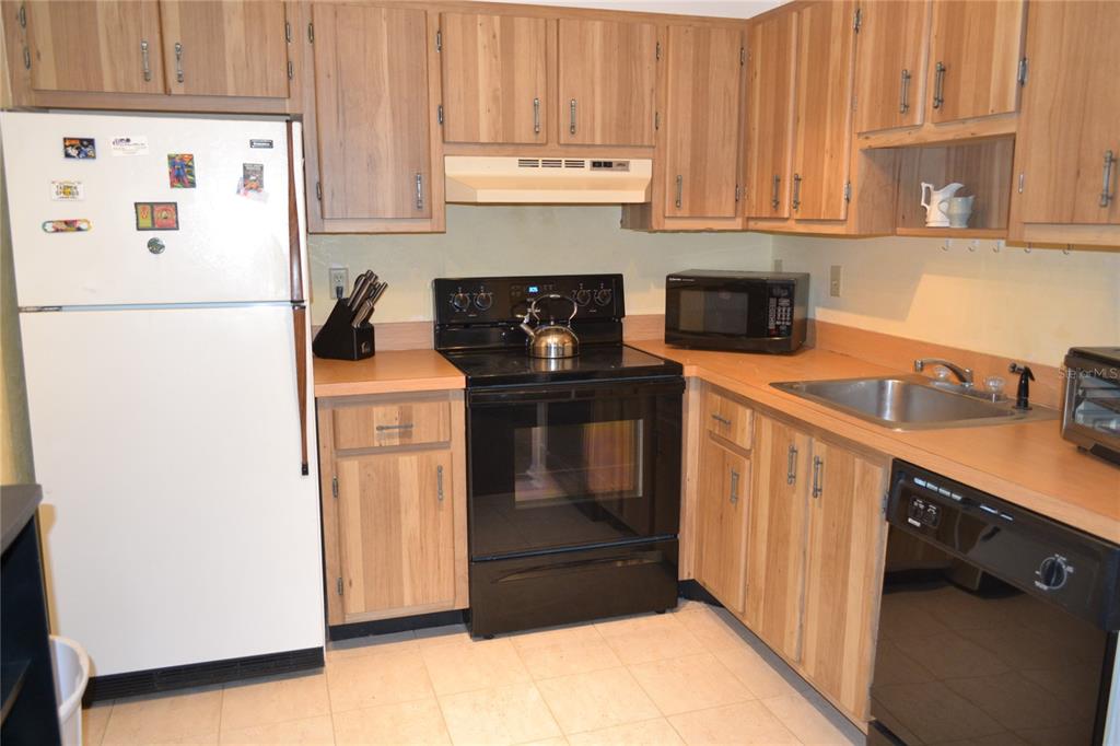 2375 Fox Chase Boulevard, Unit 260 Palm Harbor, FL 34683 - Photo 2 of 38 a kitchen with stainless steel appliances granite countertop a refrigerator and a stove