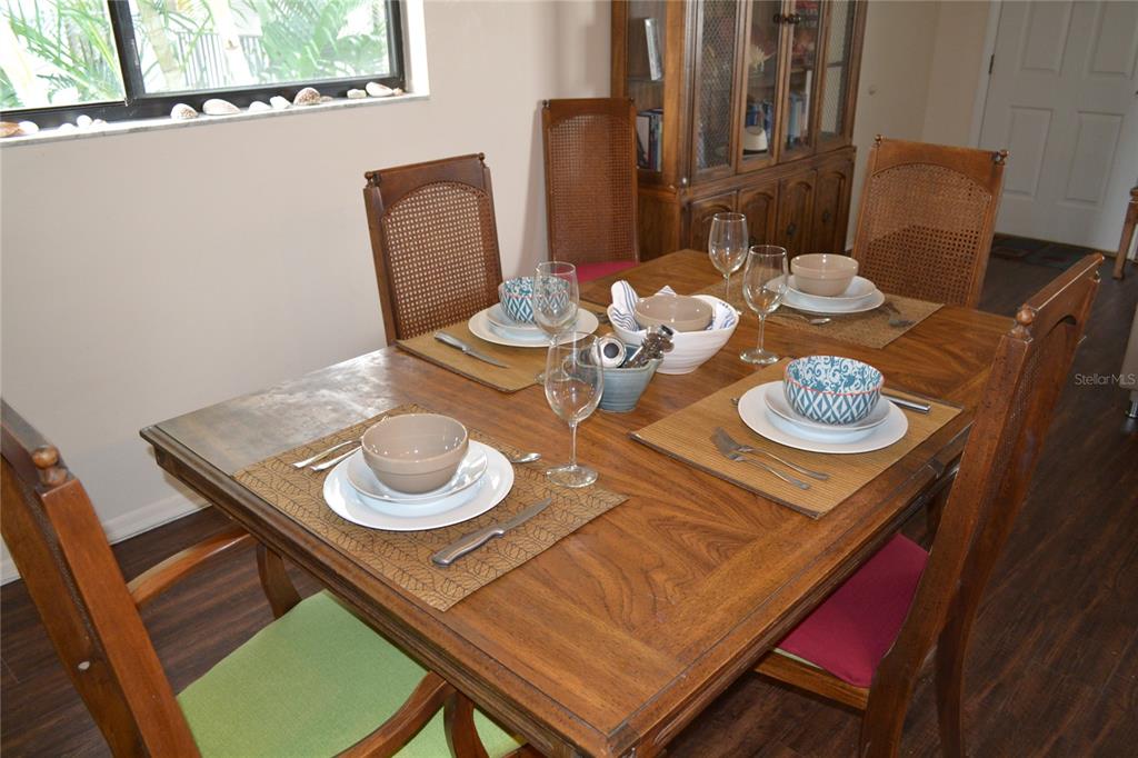 2375 Fox Chase Boulevard, Unit 260 Palm Harbor, FL 34683 - Photo 3 of 38 a dining room with furniture and wooden floor