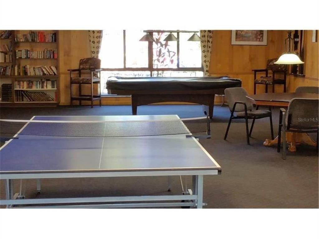 2375 Fox Chase Boulevard, Unit 260 Palm Harbor, FL 34683 - Photo 32 of 38 a kitchen view with table and chairs