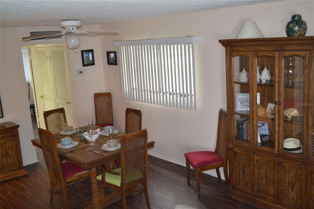 2375 Fox Chase Boulevard, Unit 260 Palm Harbor, FL 34683 - Photo 6 of 38 a view of a dining room with furniture and wooden floor