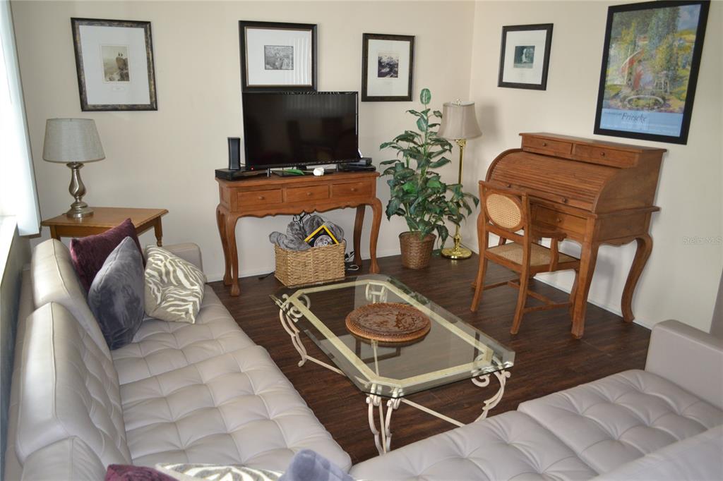 2375 Fox Chase Boulevard, Unit 260 Palm Harbor, FL 34683 - Photo 7 of 38 a living room with furniture and a flat screen tv