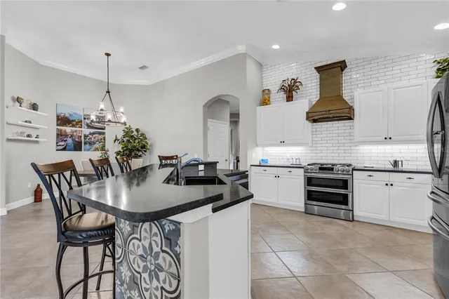a kitchen with granite countertop a sink and cabinets