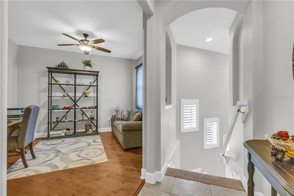 a living room with furniture a window and gym equipment