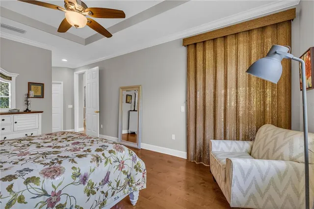 a bedroom with a bed and a chandelier