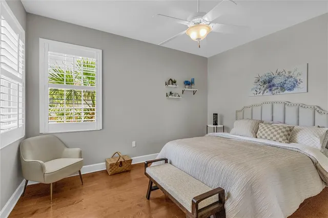 a spacious bedroom with a bed a couch and a chandelier