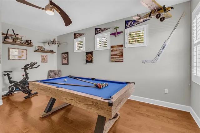 a room with furniture pool table and window
