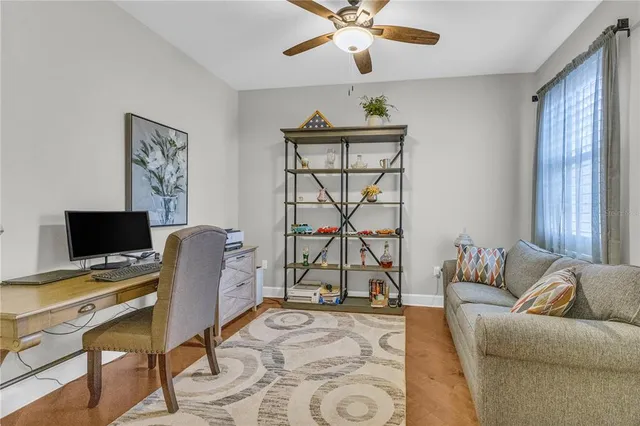 a view of a workspace with furniture and a window