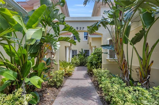 a view of a white house with a yard