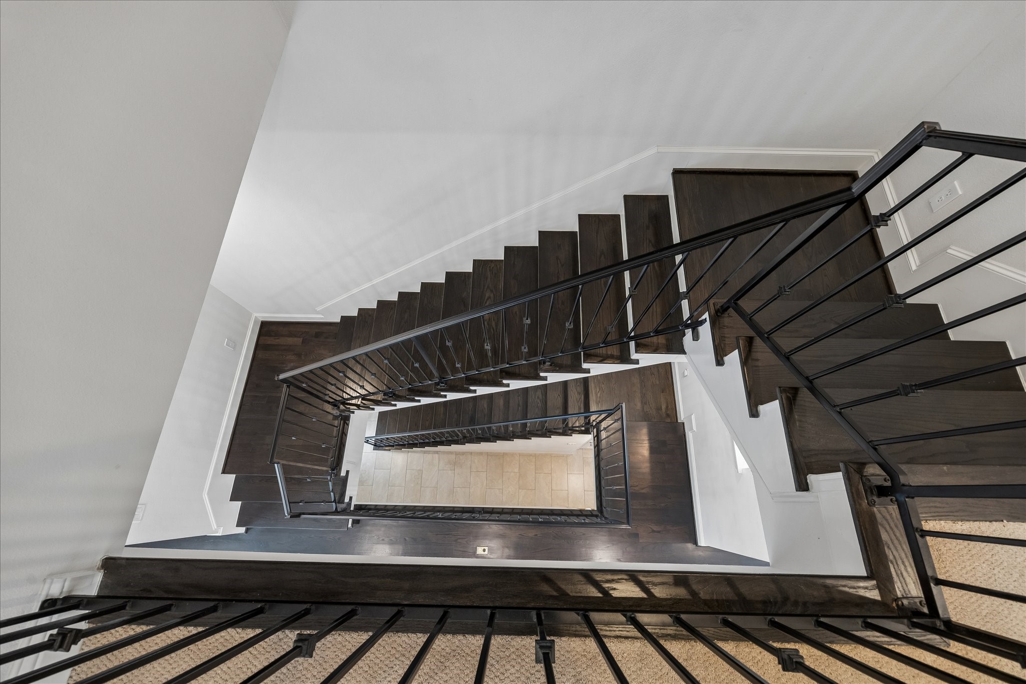 734 West 20th Street, Unit A Houston, TX 77008 - Photo 21 of 23 Striking multi-level staircase w/ rich wood treads & iron railing detail creates a dramatic architectural focal point connecting all floors.