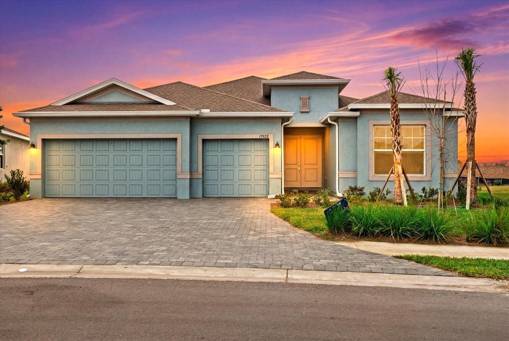17822 Cane Patch Terrace Parrish, FL 34219 - Photo 1 of 1 a front view of a house with a yard and garage