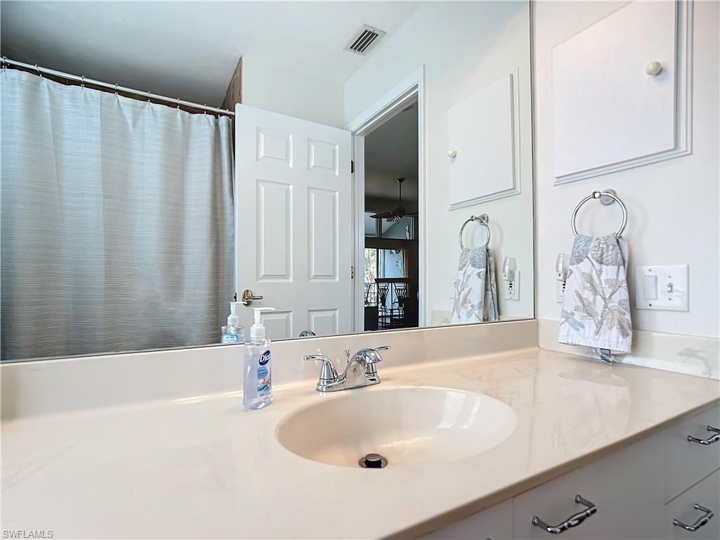 2860 Citrus Lake Drive, Unit R202 Naples, FL 34109 - Photo 29 of 50 a bathroom with a bathtub and a sink