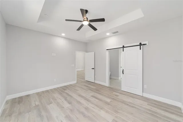 a view of an empty room with a ceiling fan