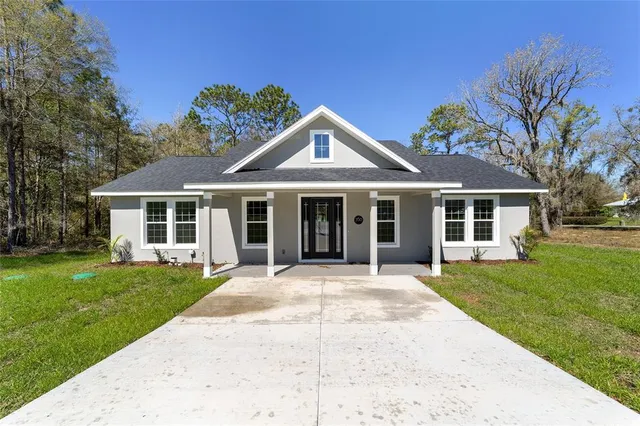 a front view of a house with a garden and porch