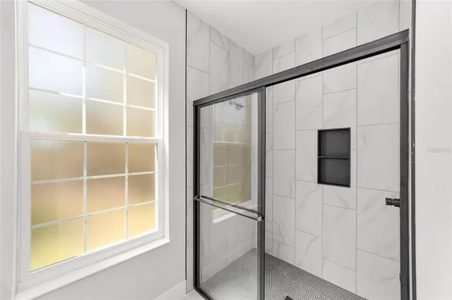 a bathroom with a walk in closet and a window