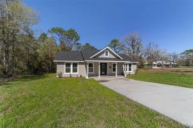 a front view of a house with yard
