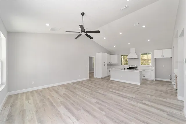 a view of a kitchen with a refrigerator and a window