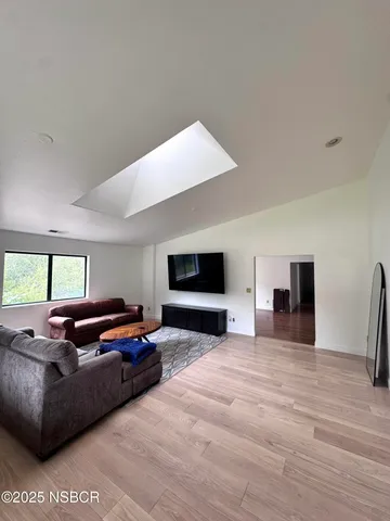 a living room with furniture flat screen tv and a fireplace
