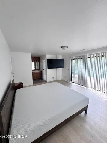 a bed room with a bed and a television