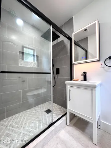 a bathroom with a sink a toilet and mirror