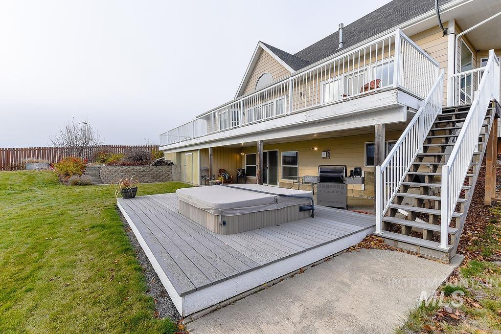 18072 Central Grd Genesee, ID 83832 - Photo 47 of 50 Back of house featuring a deck, a covered hot tub, stairway, and a shingled roof