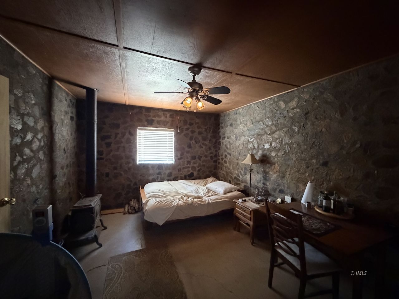 481 Downey Road Tecopa, CA 92389 - Photo 5 of 7 a bedroom with a bed and a table