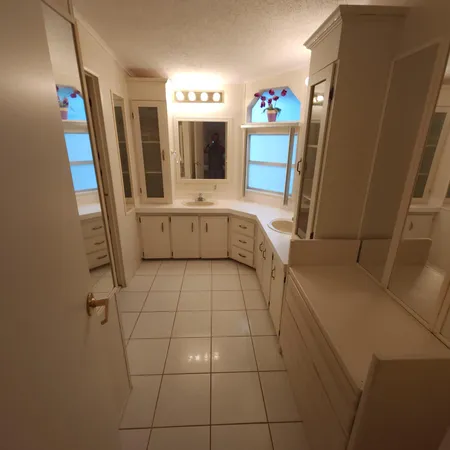 a view of bathroom with mirror and sink