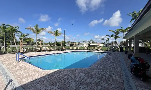 a view of a swimming pool with outdoor seating