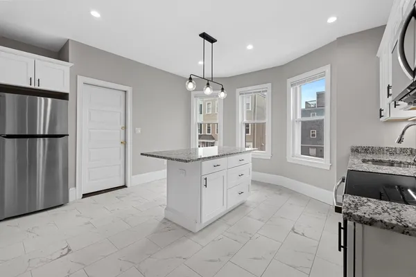 a kitchen with stainless steel appliances a refrigerator sink and cabinets