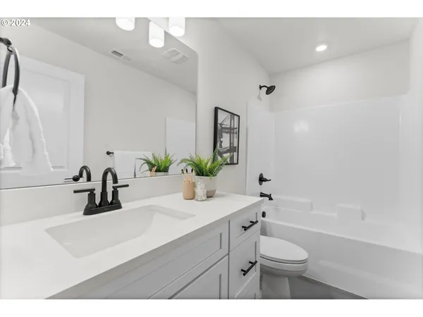 a bathroom with a sink a toilet and a tub