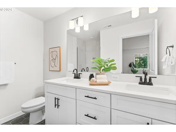 a bathroom with a sink a toilet and mirror