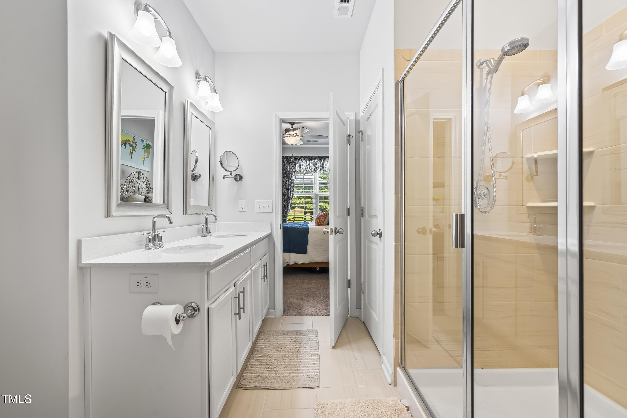 6050 Beale Loop Raleigh, NC 27616 - Photo 19 of 35 a spacious bathroom with a double vanity sink a mirror and a shower