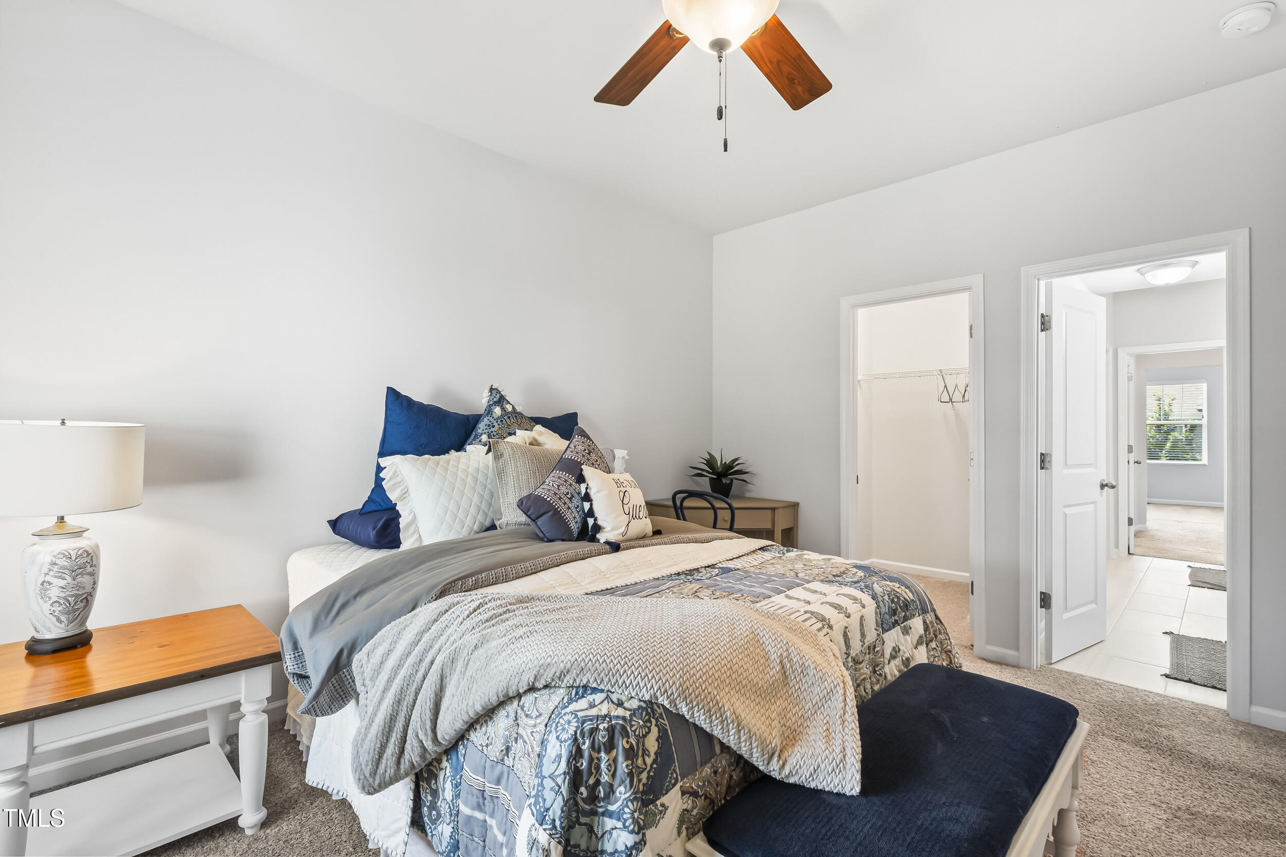 6050 Beale Loop Raleigh, NC 27616 - Photo 25 of 35 a bedroom with a bed and a chandelier