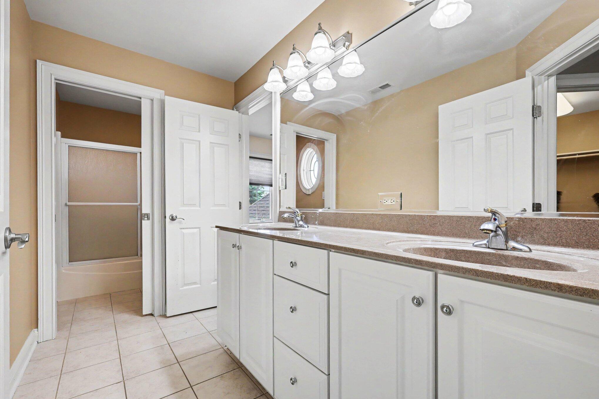 10195 Floyd Street Crown Point, IN 46307 - Photo 10 of 20 a bathroom with a sink a vanity and a mirror