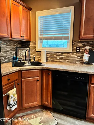 a kitchen with granite countertop stainless steel appliances a stove sink and cabinets